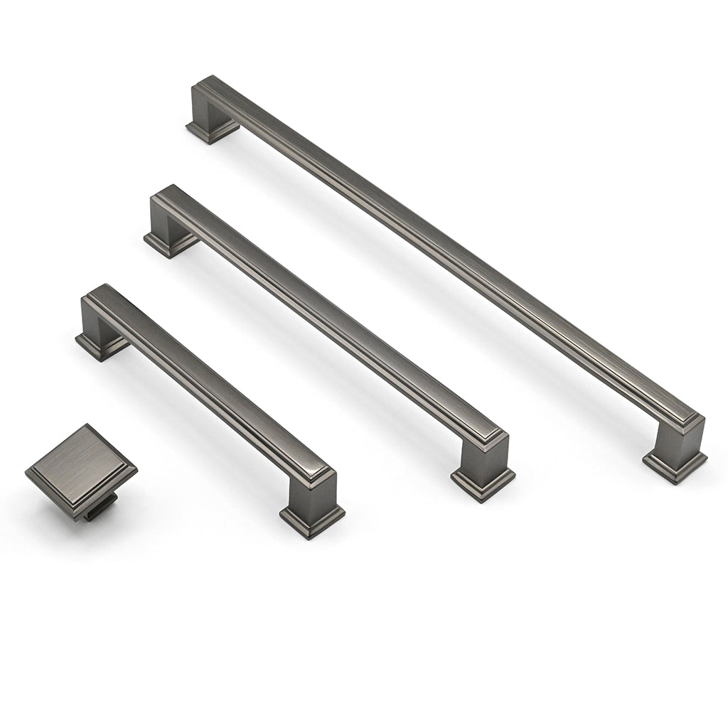 Two long metallic cabinet handles and a square knob on a white background