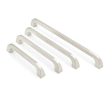 Set of four metallic cabinet handles on a white background
